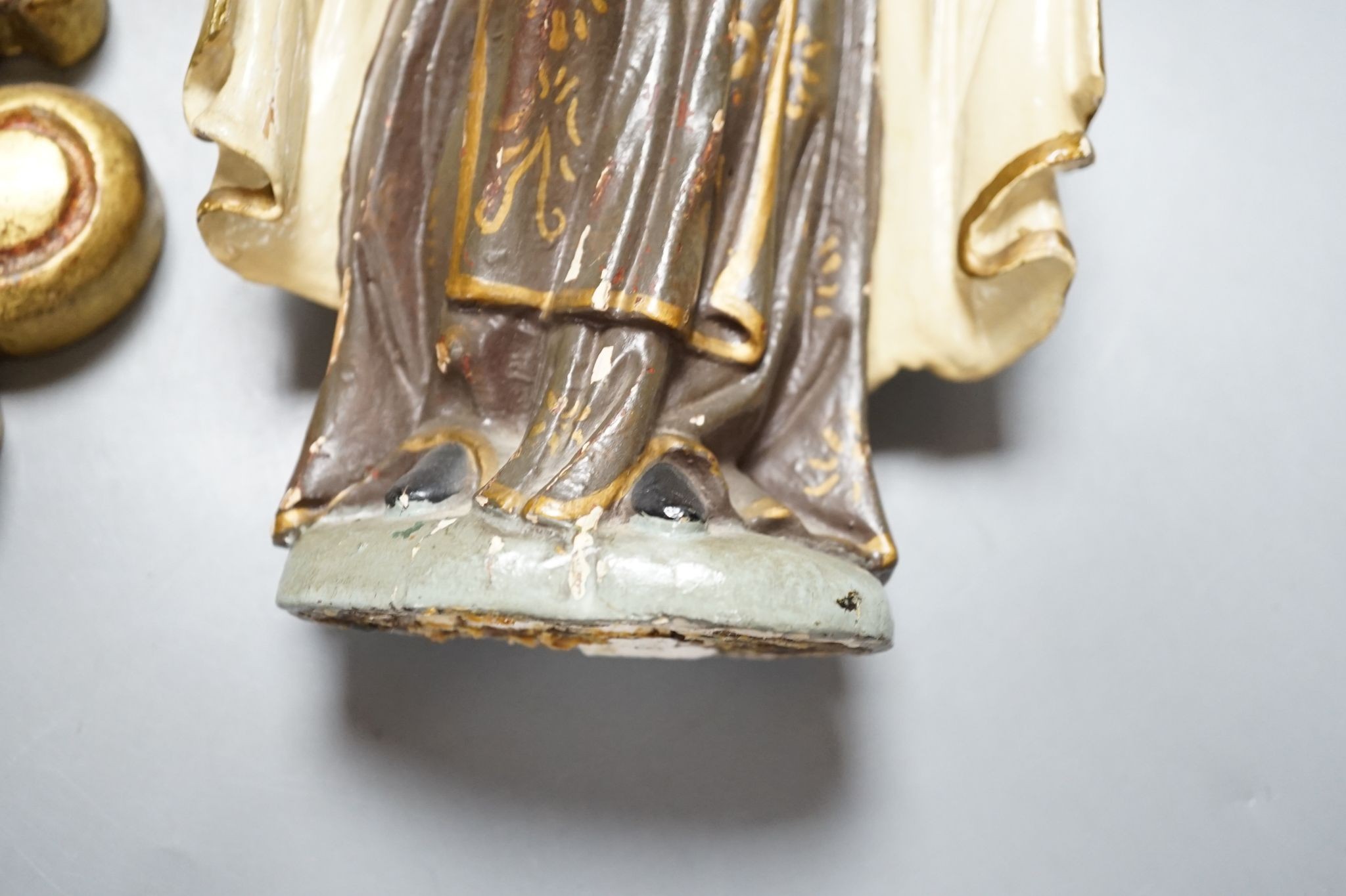 An ornate South American Madonna and child with a metal crown and halo, standing on a carved bracket, 39cm